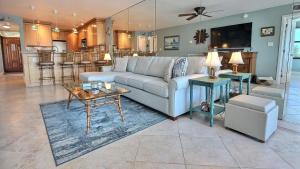 a living room with a couch and a table at B307 Moon Bay in Villa Verde