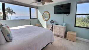 a bedroom with a bed and a flat screen tv at B307 Moon Bay in Villa Verde +34 photos