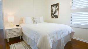 a white bedroom with a white bed and a window at B405 Moon Bay in Key Largo +40 photos