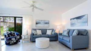 a living room with two couches and a table at C14 Moon Bay in Key Largo
