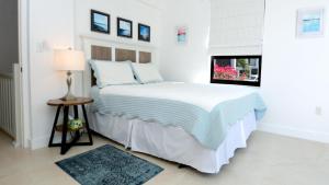 a white bedroom with a bed and a window at C14 Moon Bay in Key Largo +36 photos