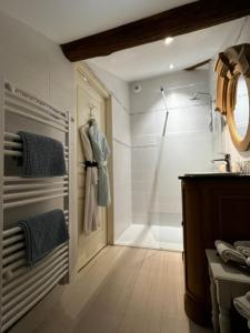 a bathroom with a shower and a sink and a door at L'Ecrin de Launac in Launac +40 photos
