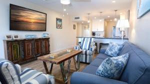 a living room with blue couches and a table at A409 Moon Bay in Key Largo