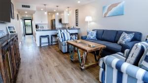 a living room with a blue couch and a table at A409 Moon Bay in Key Largo
