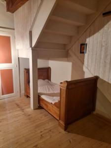 a bedroom with a wooden bed in a room at Chez Flo in Lamastre