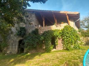 a stone house with vines growing around it at Chez Flo in Lamastre