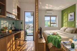 a bedroom with a bed with a green wall at Seaflow Staycation in Danang