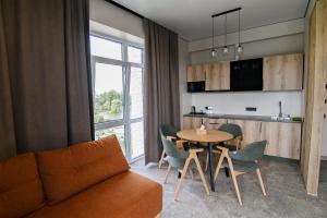a living room with a couch and a table at Kryla by Shepilska in Dolgoluka
