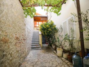 an alley with stairs and plants in front of a building at Apartment Krianca in Zadar