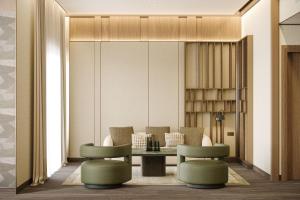 a living room with a table and chairs at The Ritz-Carlton Jakarta, Pacific Place in Jakarta