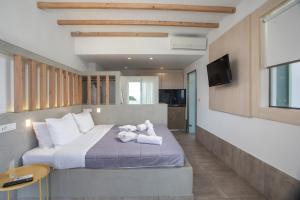a bedroom with a bed with a teddy bear on it at Alexander Studios & Suites - Adults Only in Faliraki