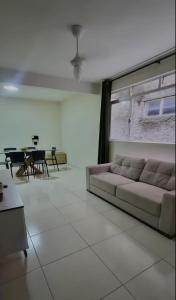 a living room with a couch and a table at Intermares perto de tudo com 3 quartos in Cabedelo