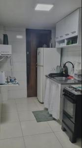 a kitchen with a stove and a refrigerator at Intermares perto de tudo com 3 quartos in Cabedelo
