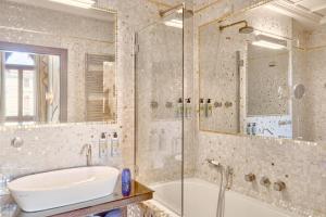 a bathroom with a tub and a sink and a shower at Hotel Palazzo Stern in Venice +59 photos