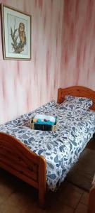a bed with a blue and white comforter on it at La fermette de Vrinette in Saint-Vérain