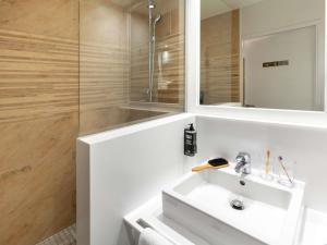 a bathroom with a white sink and a shower at ibis Styles Biarritz Plage in Biarritz