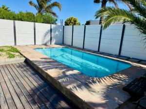 a swimming pool in a backyard with a fence at Hideaway Haven 2 in Cape Town