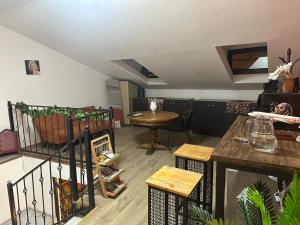 a living room with a table and a table and chairs at Tbil Inn Hotel in Tbilisi City