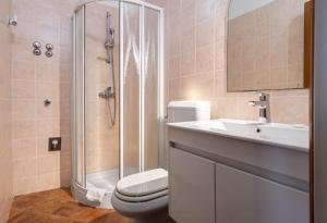 a bathroom with a shower and a toilet and a sink at Villa Kontesa in Lovran +35 photos
