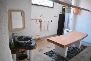 a bathroom with a wooden table and a mirror at M Villa’s Farm Resort in Romblon