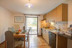 a kitchen with a table and a dining room at Ca Cornocc with Private Terrace in Gordola - Happy Rentals in Gordola