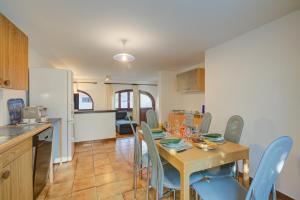 a kitchen and dining room with a table and chairs at Ca Cornocc with Private Terrace in Gordola - Happy Rentals in Gordola