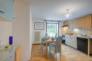 a kitchen with a table and chairs in a room at Ca Cornocc with Private Terrace in Gordola - Happy Rentals in Gordola