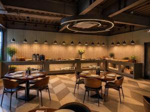 a restaurant with tables and chairs in a room at Click Hotels Lite Chakan in Pune