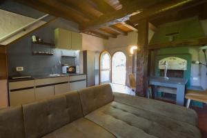 a living room with a couch and a kitchen at Dimora Dory Luxury in Nave