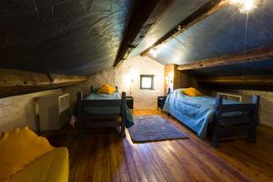 a bedroom with two beds in a attic at Dimora Dory Luxury in Nave