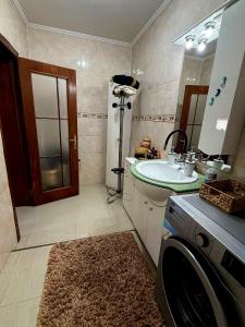 a bathroom with a sink and a washing machine at Casa Elena in Râmnicu Vâlcea +58 photos