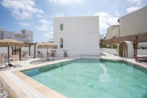 a swimming pool on the side of a building at Alexander Studios & Suites - Adults Only in Faliraki