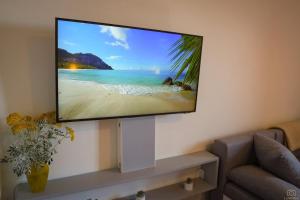 a flat screen tv hanging on a wall in a living room at Castello in Mali Lošinj