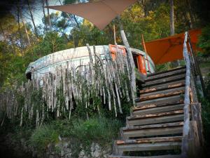 a staircase with an umbrella and an old van at Le Ptit Mas Yourte ou Logicube in Salernes