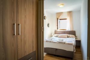 a small bedroom with a bed and a window at Castello in Mali Lošinj