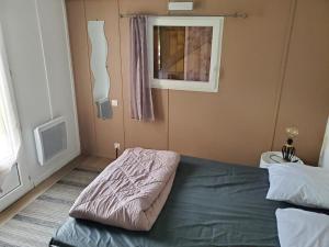 a bedroom with a bed and a window at Chalets du Causse 2 in Gelle