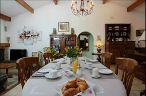 a dining room with a table with a croissant on it at Les Anthémis in Gujan-Mestras