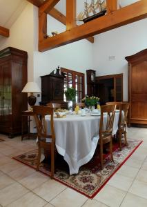 a dining room with a white table and chairs at Les Anthémis in Gujan-Mestras +14 photos