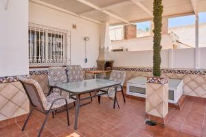a patio with a table and chairs and a fireplace at Dúplex céntrico, 2 grandes terrazas in Nerja