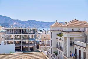 a view of a city with buildings and the water at Dúplex céntrico, 2 grandes terrazas in Nerja