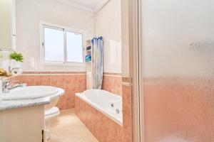a bathroom with a toilet and a sink and a shower at Dúplex céntrico, 2 grandes terrazas in Nerja +20 photos