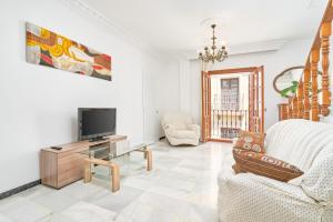 a living room with a tv and a couch at Dúplex céntrico, 2 grandes terrazas in Nerja