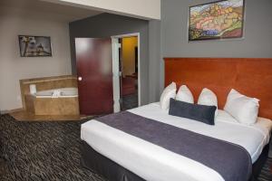 a hotel room with a bed and a bath tub at Parke Regency Hotel & Conference Center in Bloomington +16 photos
