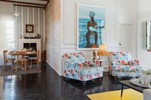 a living room with two chairs and a table at Artful Hideaway with Pool & Fireplace in Riebeek-Kasteel