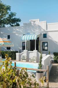 a house with a swimming pool in front of it at Artful Hideaway with Pool & Fireplace in Riebeek-Kasteel