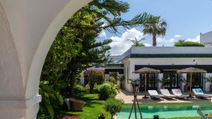 an archway leading to a resort with a swimming pool at Villa NoYa in Oualidia