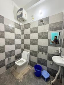 a bathroom with a toilet and a sink at Keshav Vatika Palace - 800 meter Ram Mandir in Ayodhya