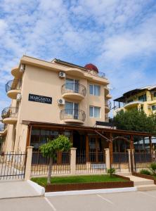 a building with a fence in front of it at Hotel Margarita in Kranevo