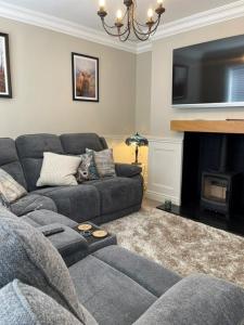 a living room with a couch and a fireplace at Ambermay House in Armagh