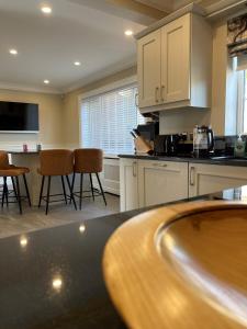 a kitchen with a counter top and chairs in it at Ambermay House in Armagh